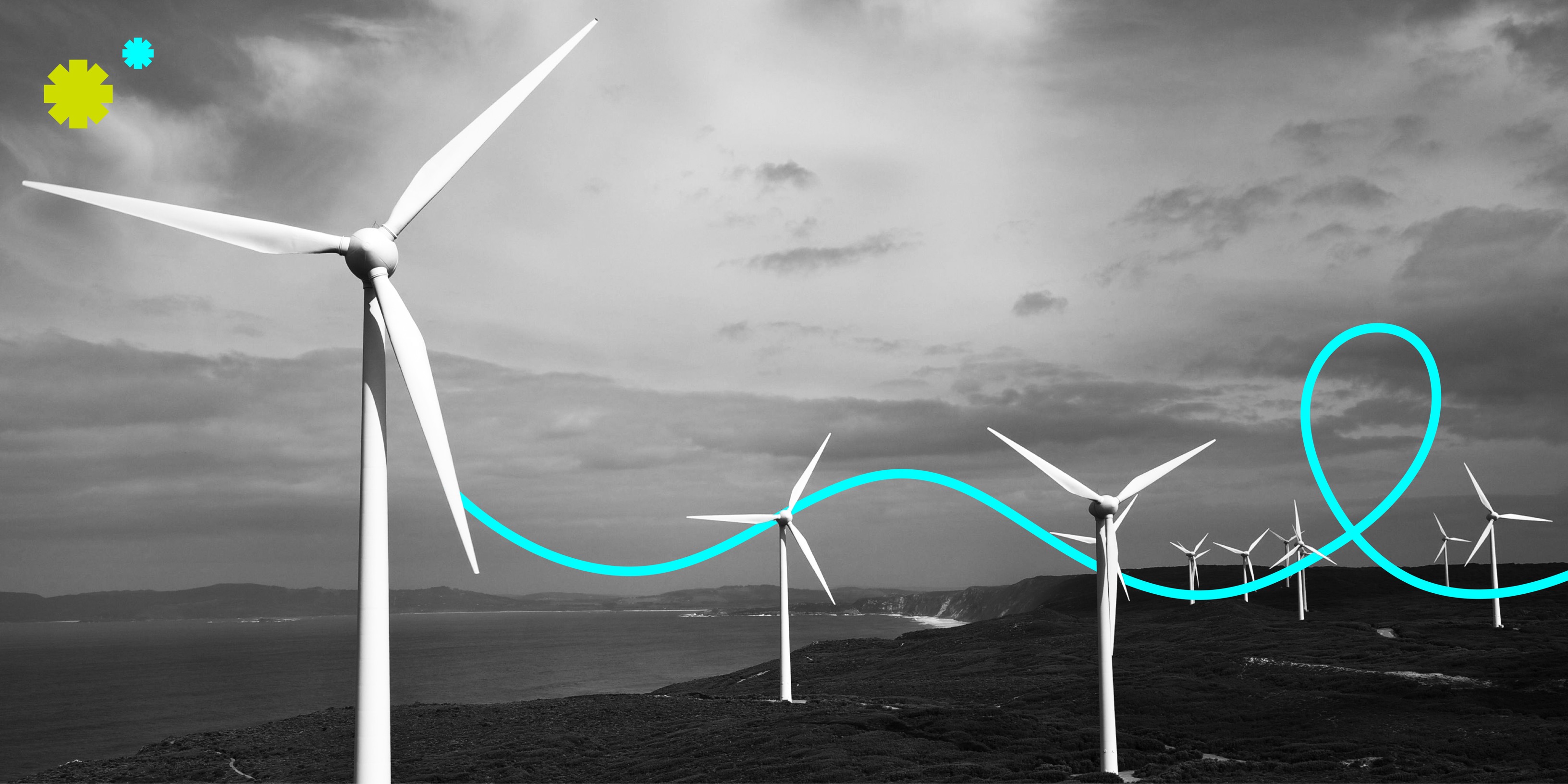 A black and white photograph of wind turbines on the coastline.