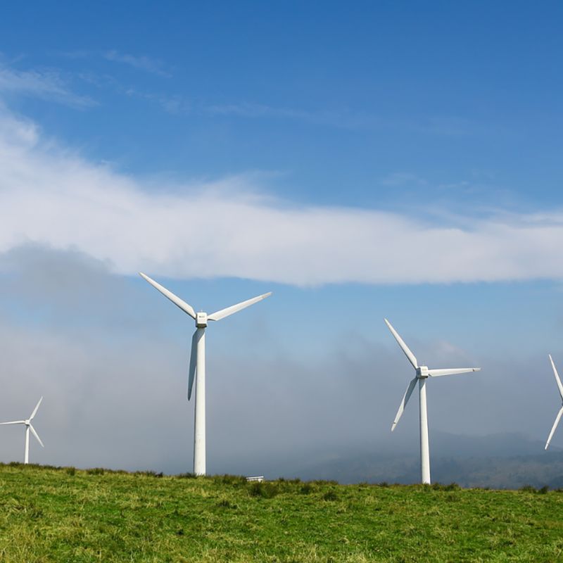 Wind turbines in a row in an open field