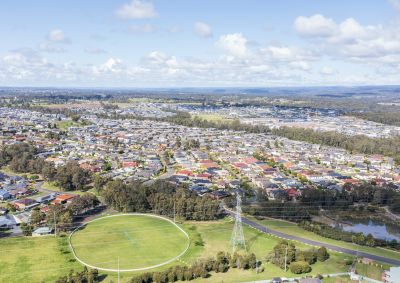 aerial view of an Australian suburb with a sports field in the foreground